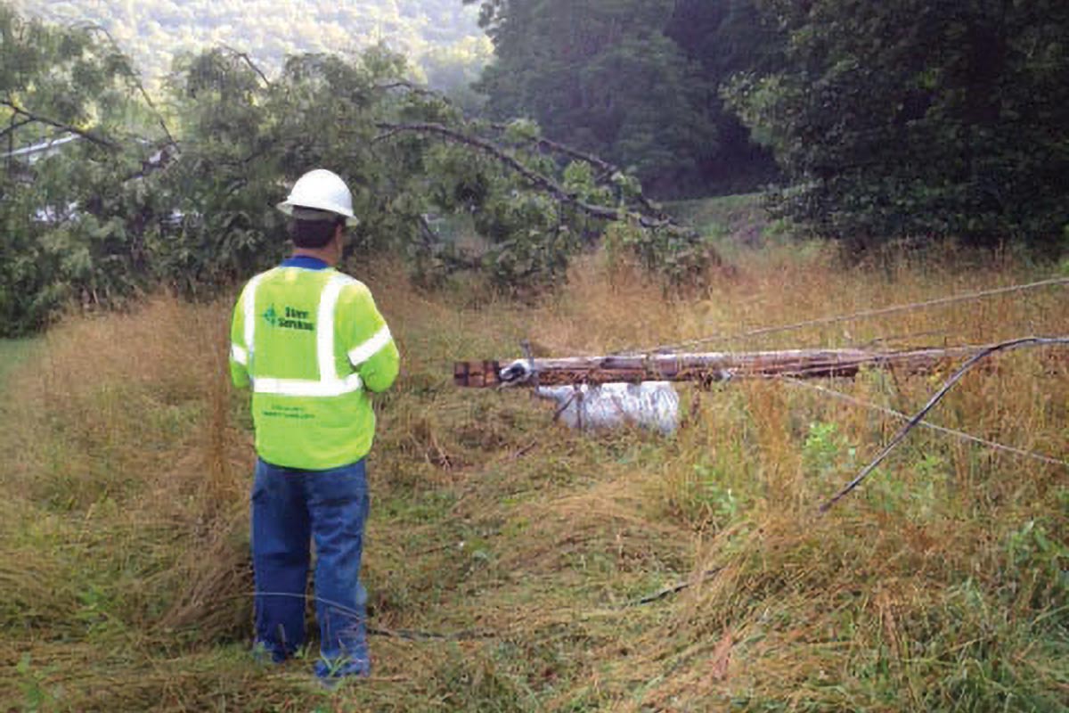 Damage assessor overlooks storm damage.